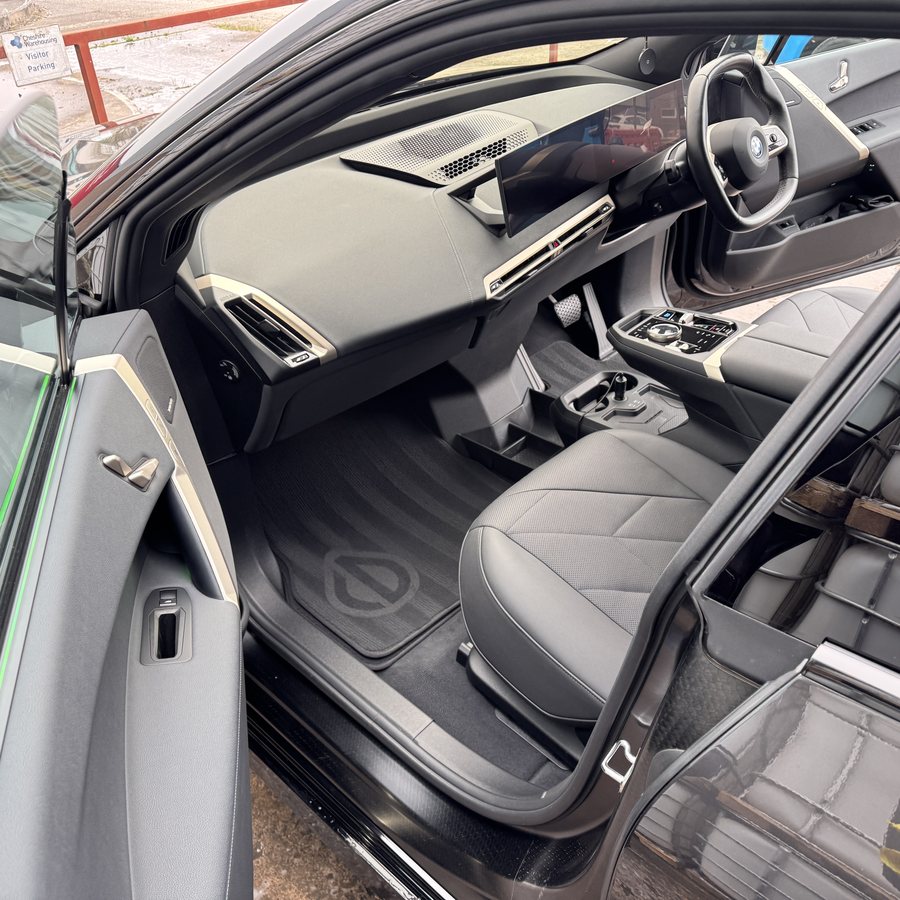 Logo set into the mat of a BMW iX