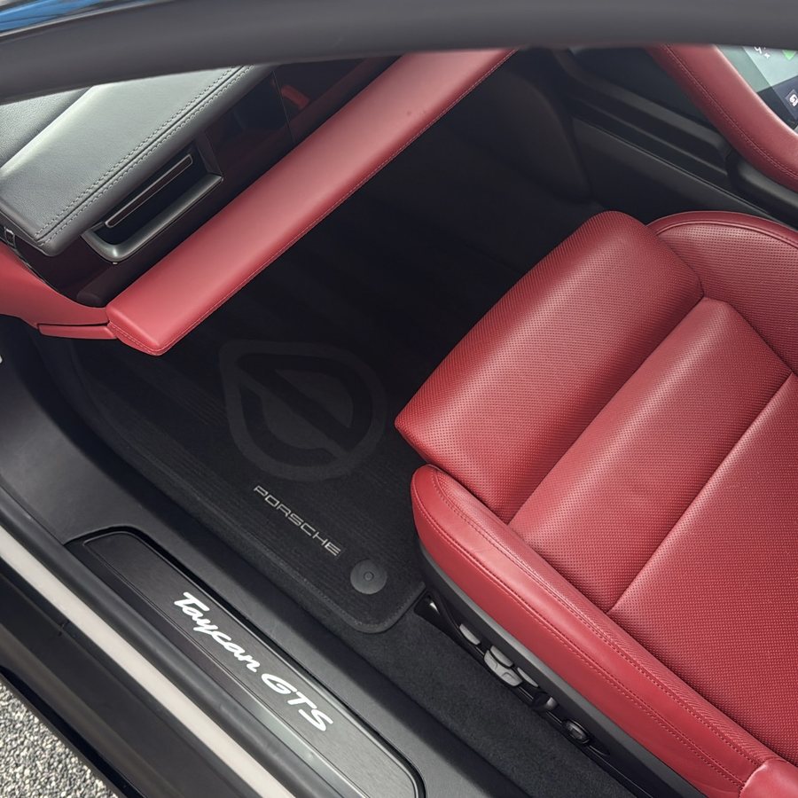 Logo set into the floor mat of a Porsche Taycan
