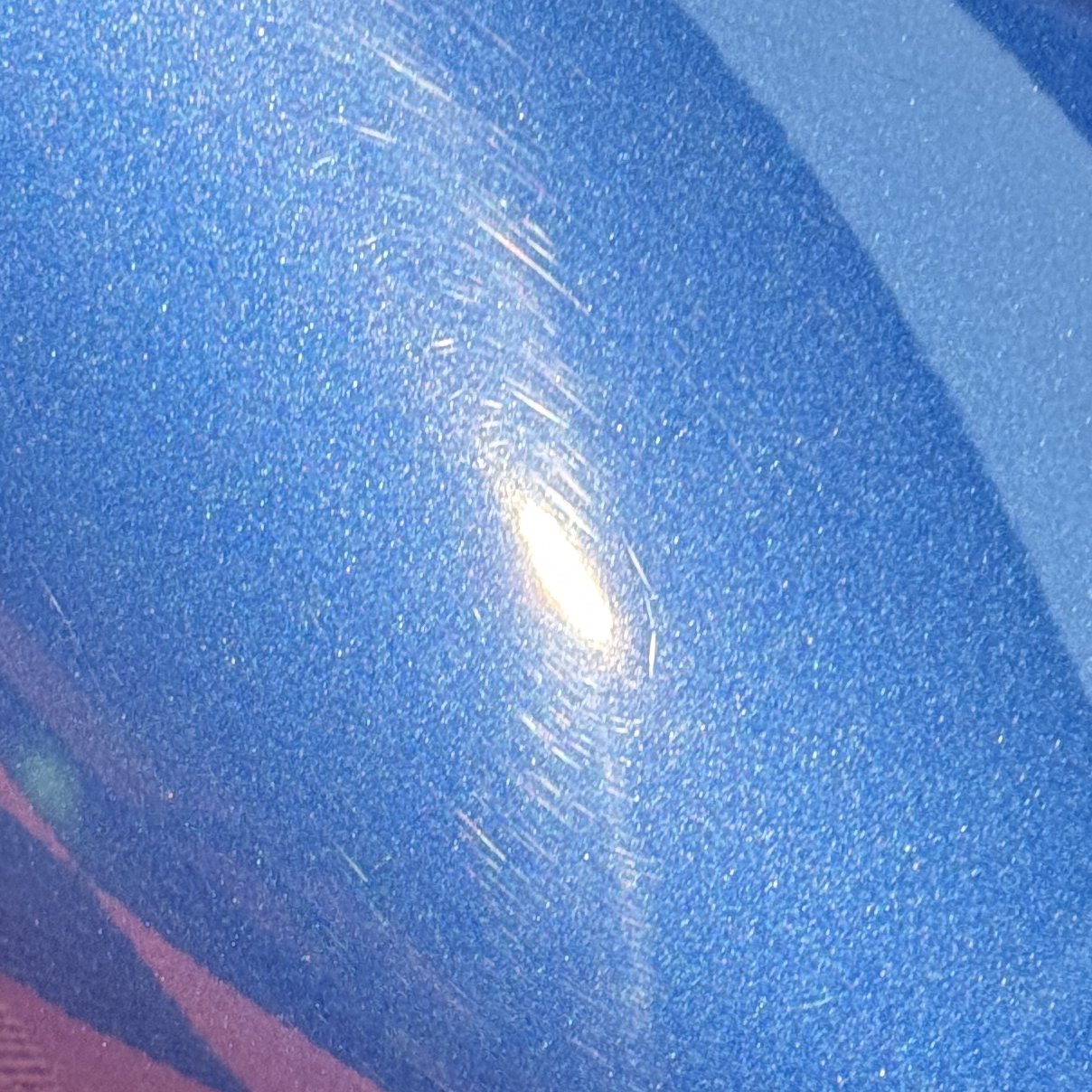 Audi R8 rear quarter before polishing, the light smeared into a flare
