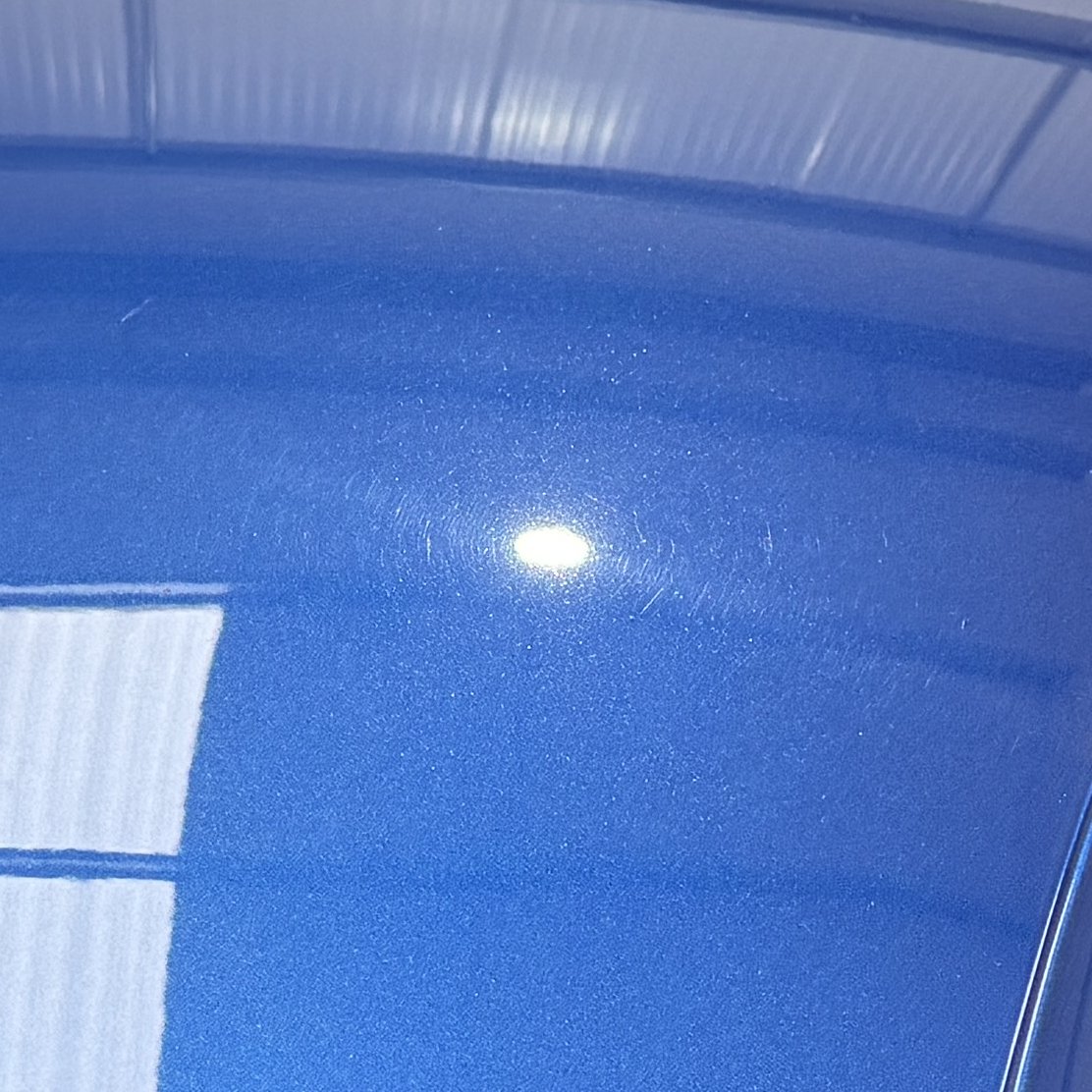 Audi R8 roof before polishing, fine linear marring across the panel